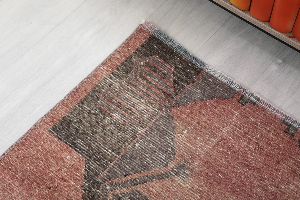 Close-up of a section of the runner, showing the intricate details of the black and rose design.