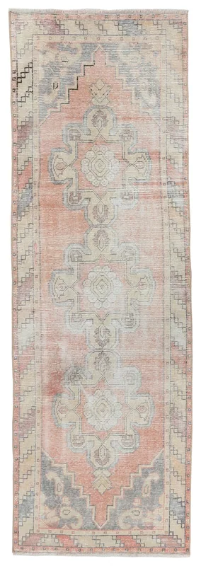 Full overhead view of the rose, gray, and ivory geometric vintage Anatolian runner