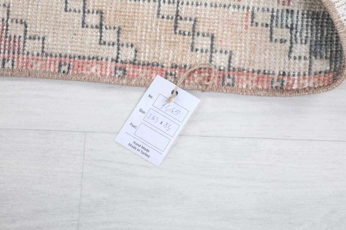 Information tag attached to the rug's corner, displaying size and origin