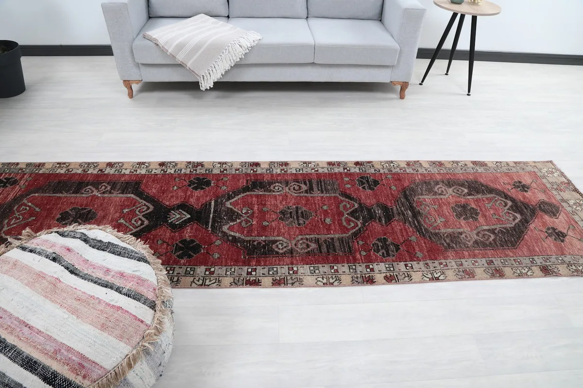 Full room view of the red runner rug, demonstrating its scale in a living area