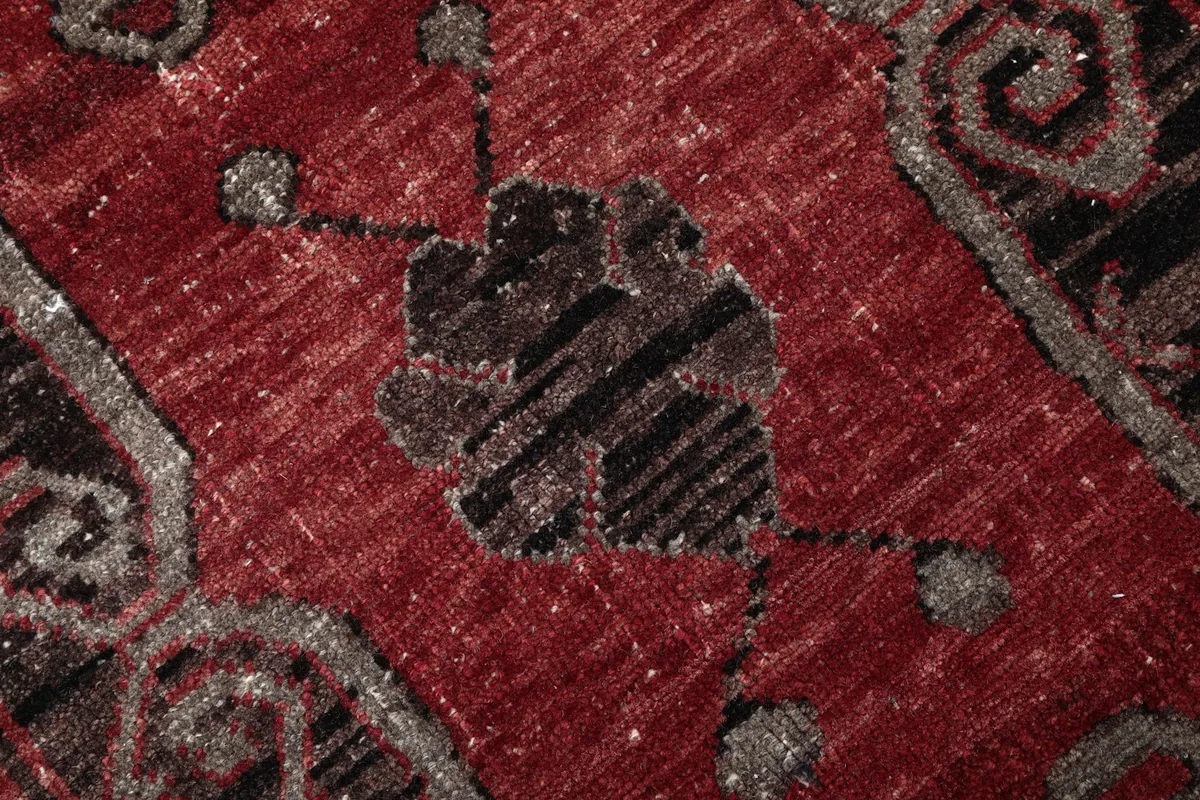 Detailed view of the low wool pile and hand-knotted texture of the rug