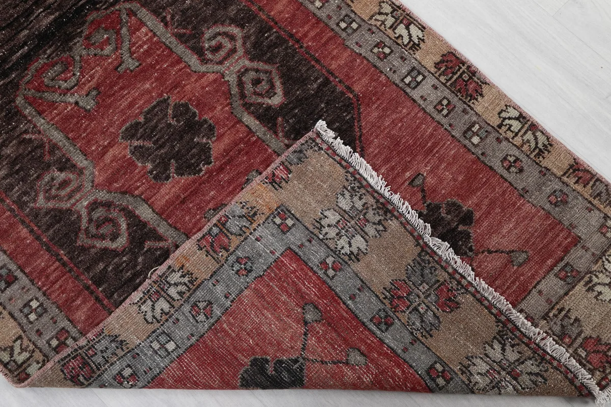 Corner of the rug folded back to show the reverse side and knotting