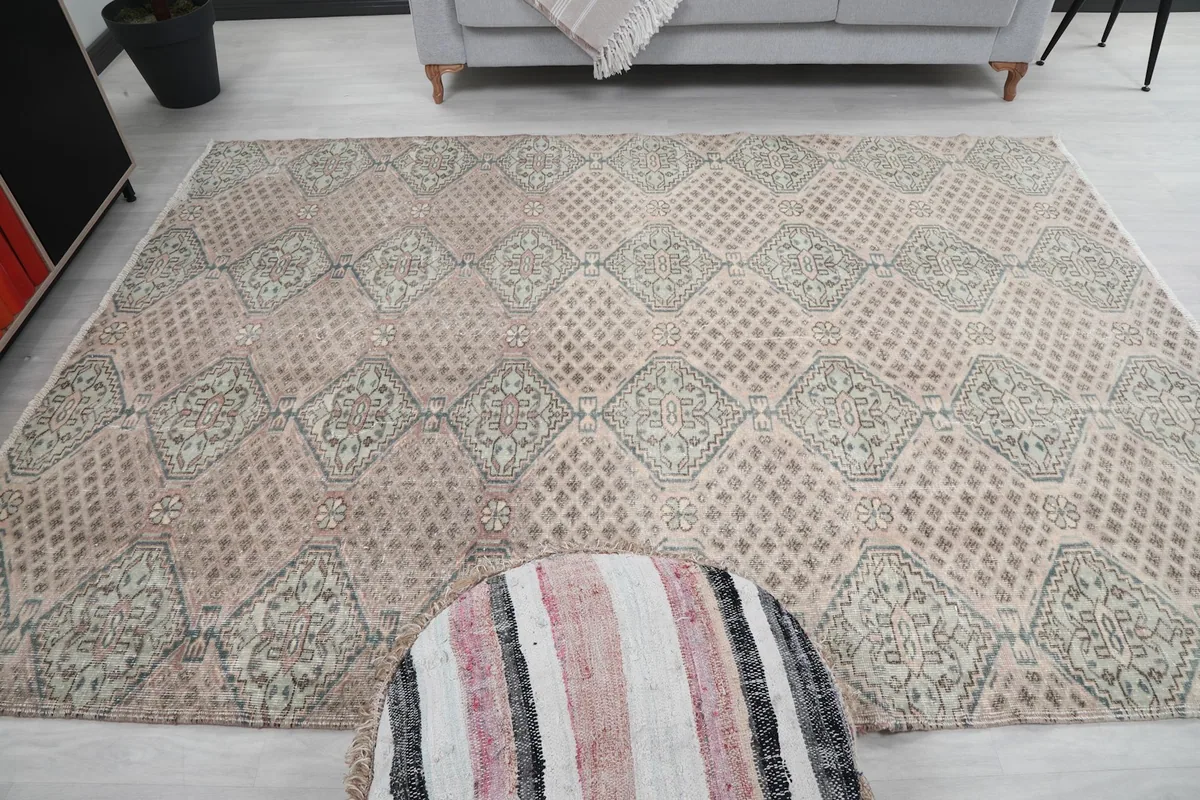Overhead perspective of the rug in the room, capturing its full pattern and placement with an ottoman.
