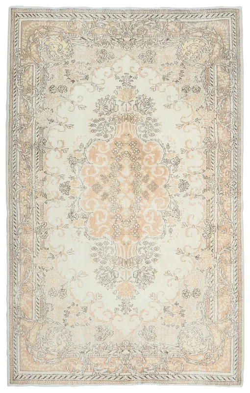 Full top view of the ivory and rose vintage Anatolian area rug on a white background