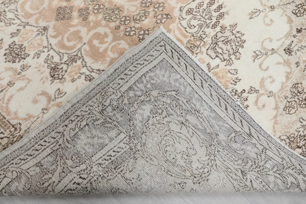 View of the back of the hand-knotted rug, revealing the cotton foundation and knotting