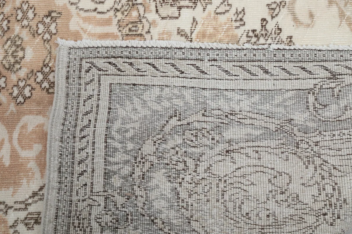 Close-up of the rug's fringe and a section of the back, showing craftsmanship