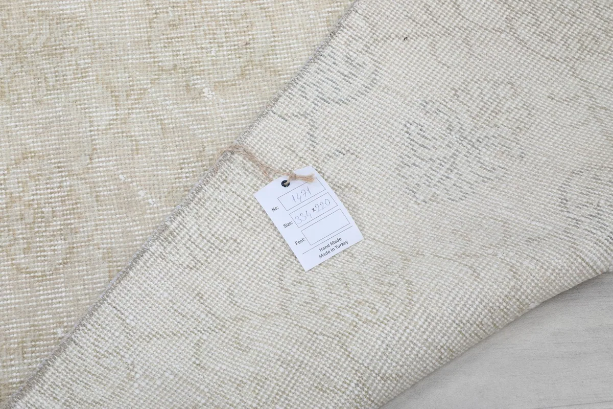 Close-up of the rug's label, confirming its origin and material, with the back of the rug visible.