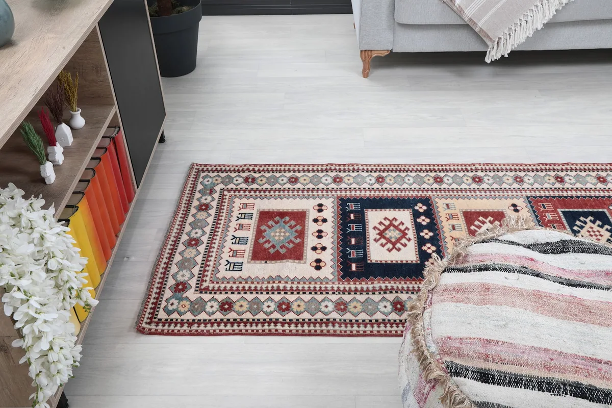 Angled view of the runner rug in a room, showing its texture and pattern from a lower perspective.