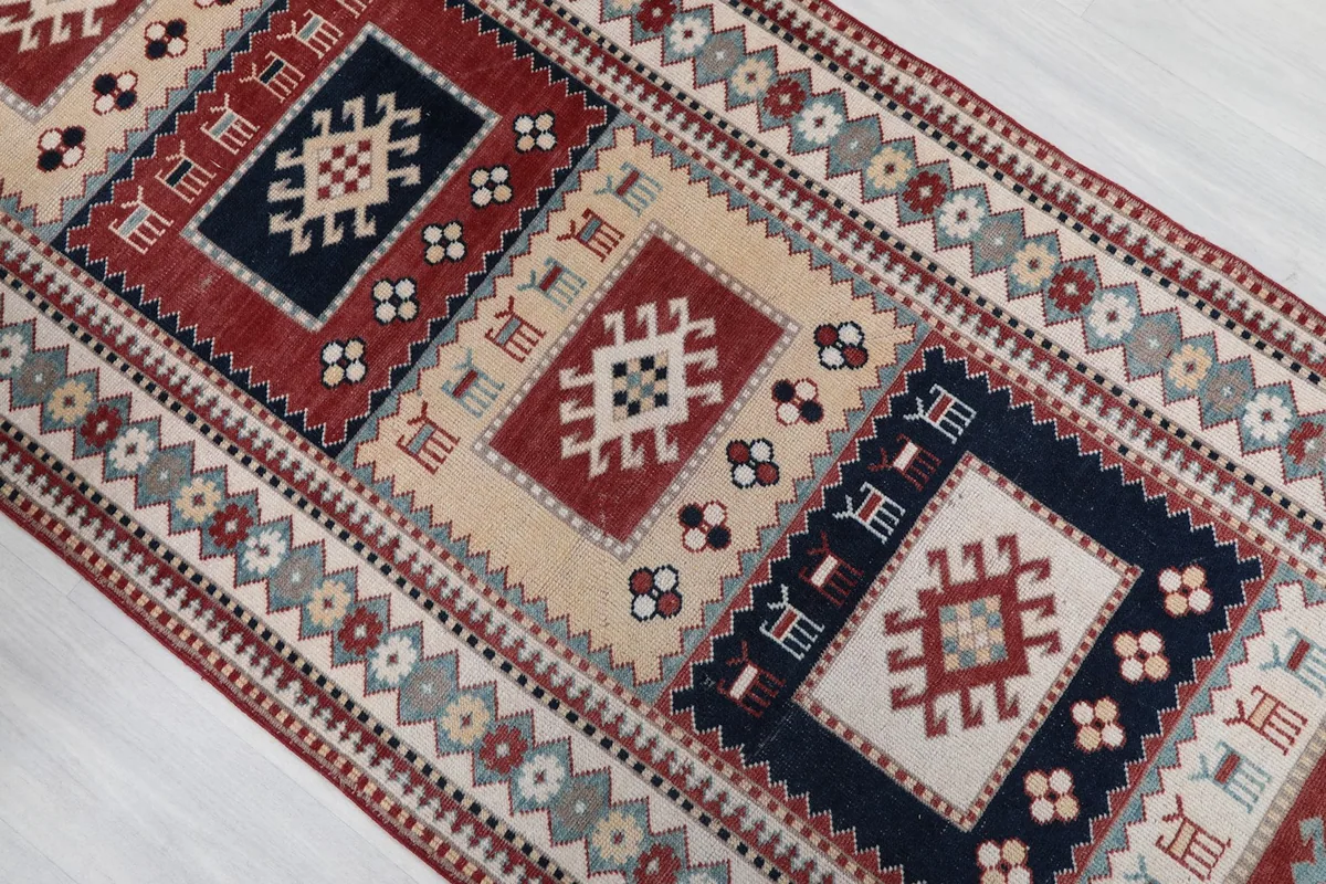 Overhead detail of the rug's central design, showcasing alternating red and navy geometric sections.