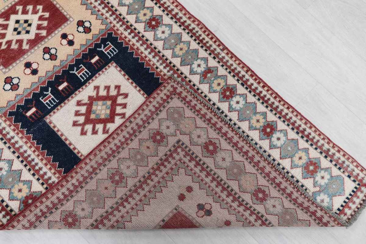 Partial view of the back of the hand-knotted rug, revealing the cotton foundation and knotting.