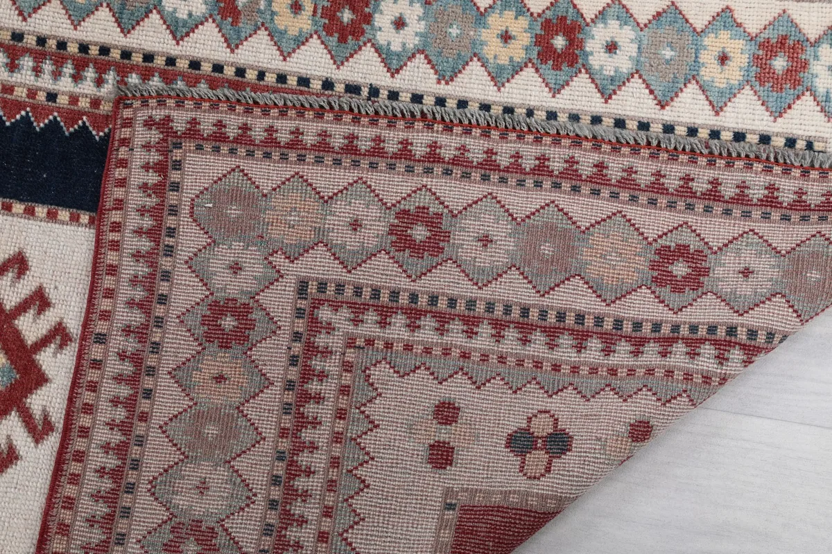 Detailed view of the rug's backing and a turned-over corner, showing the craftsmanship.