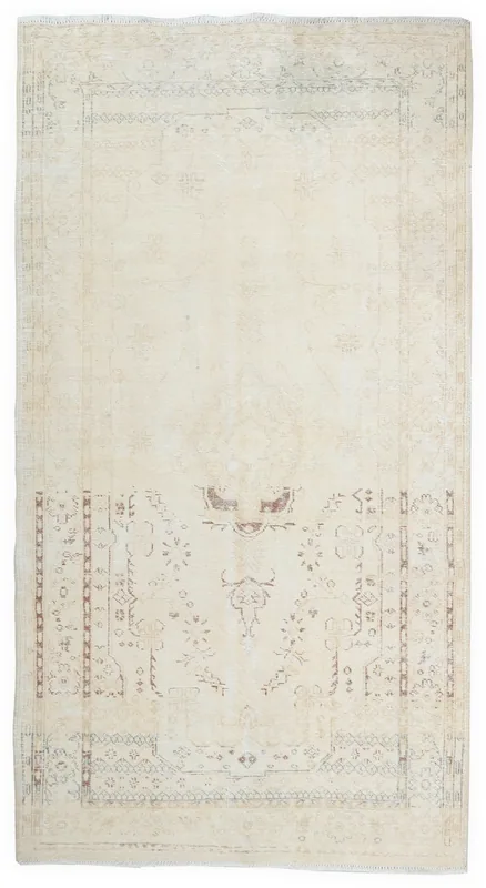 Full top view of the vintage Anatolian rug with ivory field and faded rust and gray patterns