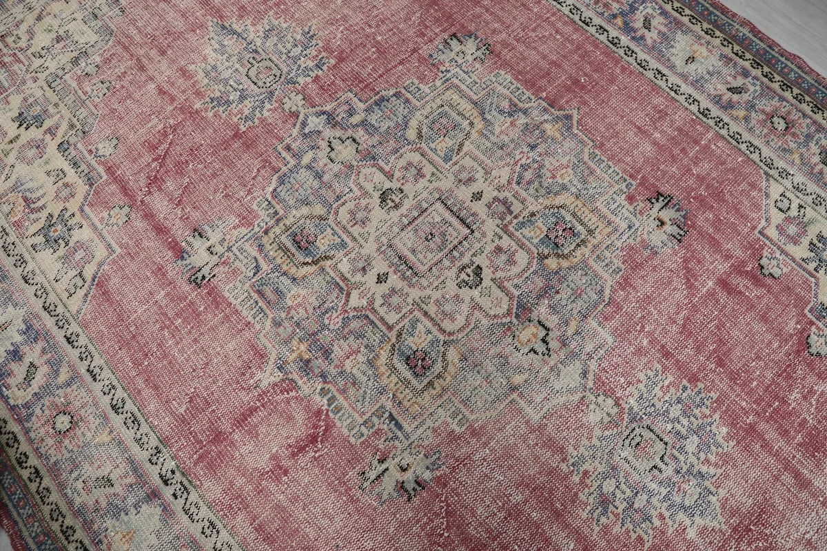 Close-up of the central medallion with blue, beige, and purple geometric patterns