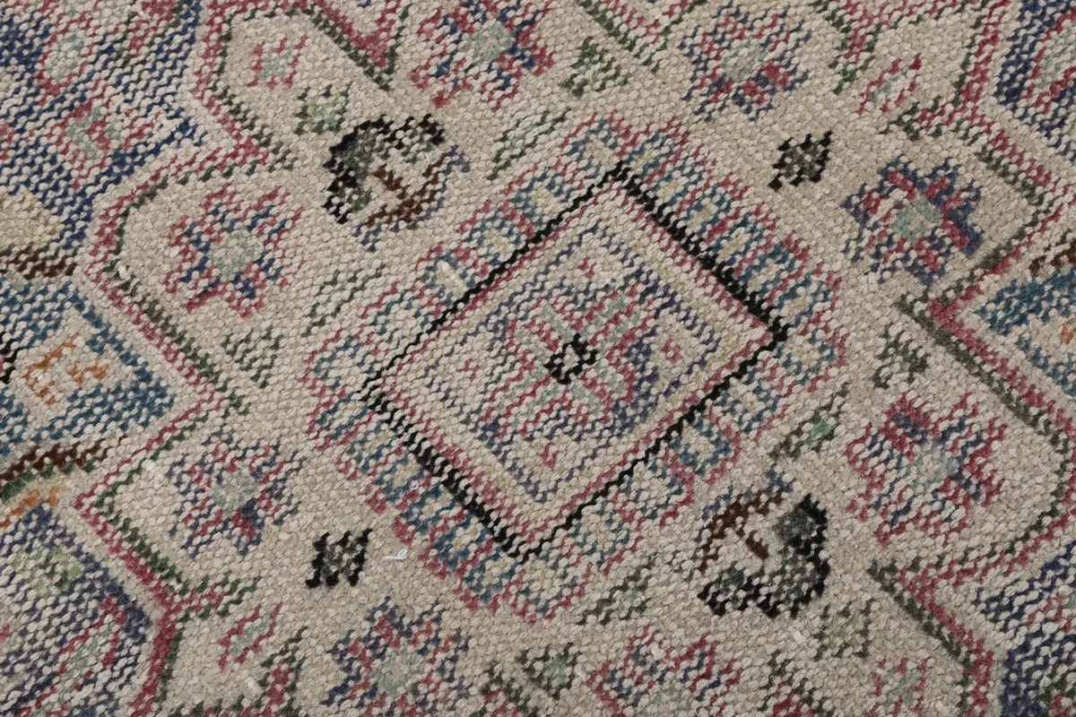Macro view of the hand-knotted wool pile, showing texture and subtle color variations
