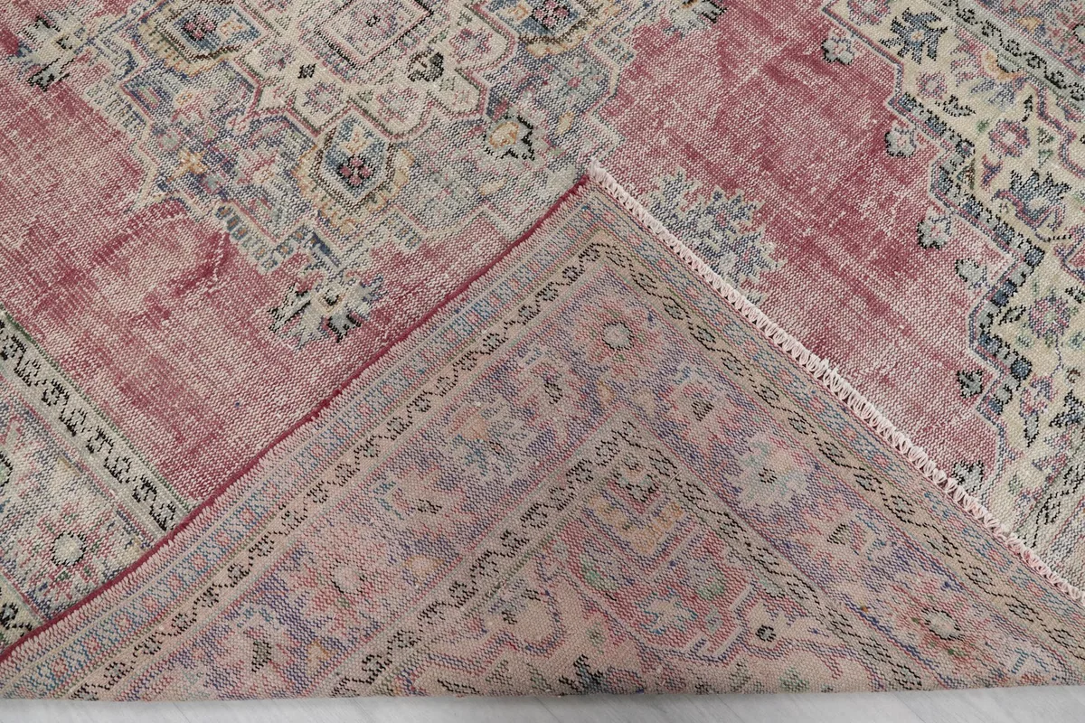 Folded corner revealing the back of the hand-knotted wool rug and its cotton foundation