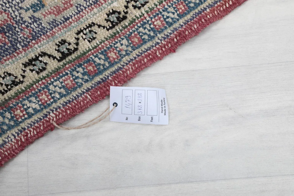 Close-up of the rug's back with a product tag showing size and origin information