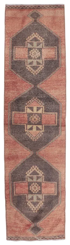 Full overhead view of the vintage Anatolian runner rug with rose and charcoal geometric patterns.