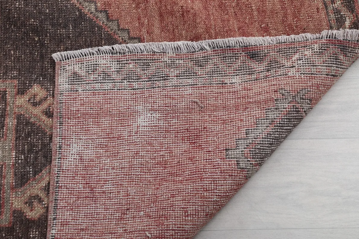 Close-up of the rug's reverse side, showing the tightly woven knots and foundation.