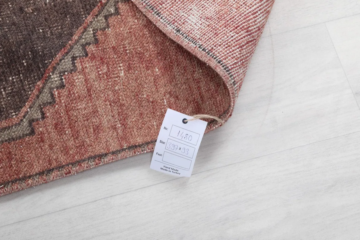 Corner of the rug with a tag displaying product information.