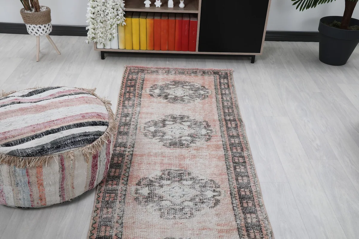 Runner displayed in a room, emphasizing its long, narrow shape and repeating medallion motifs