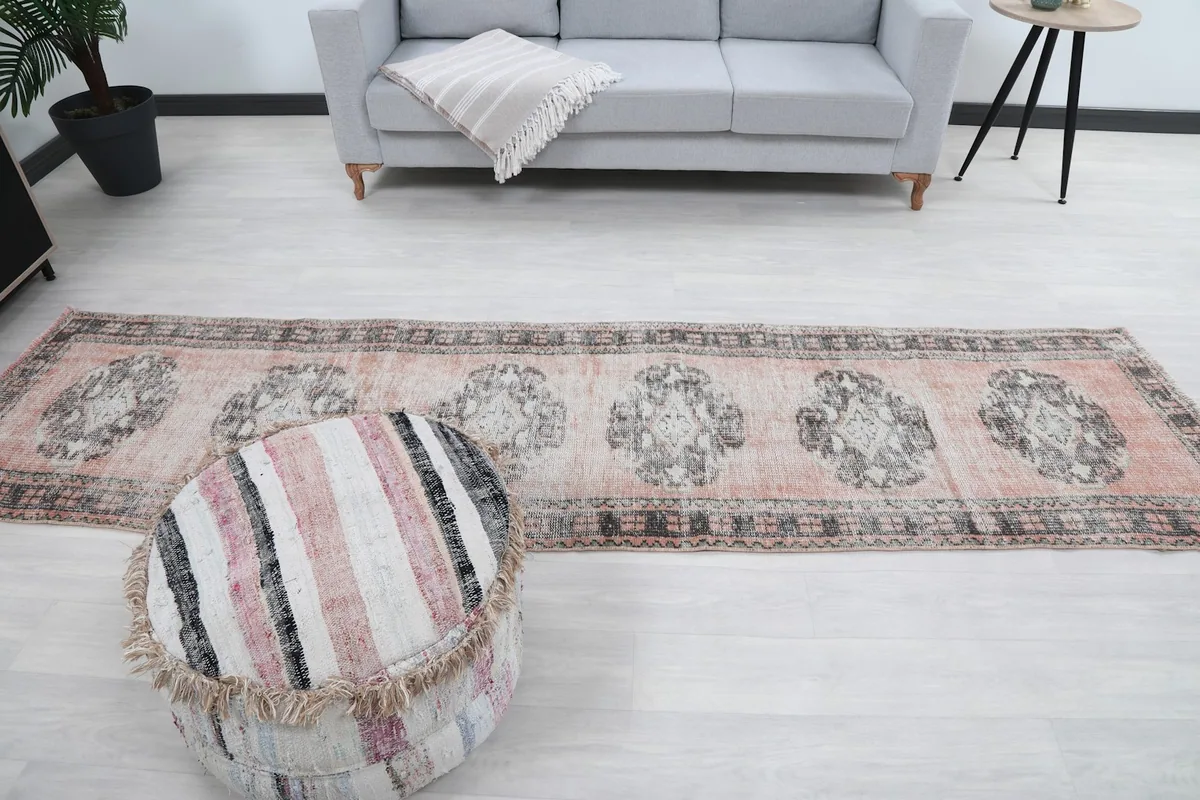 Full length of the runner in a room, showing its placement relative to a sofa and ottoman