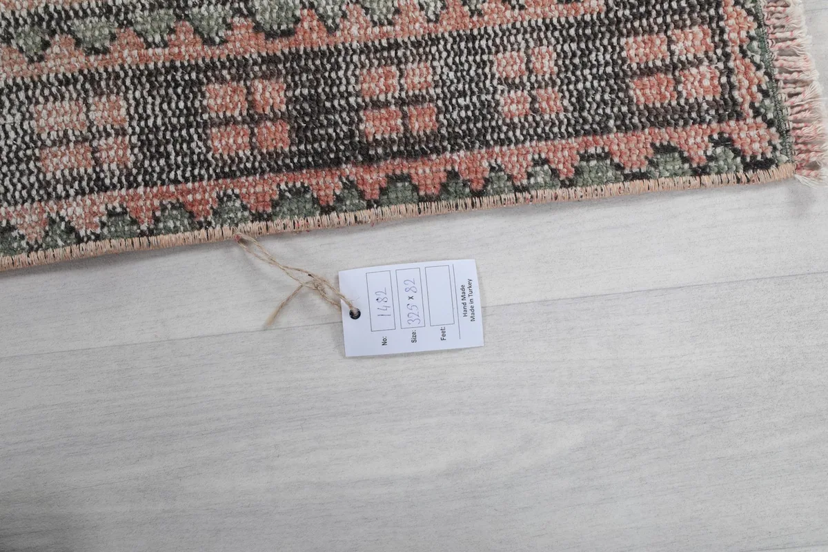 Close-up of the rug's edge with a product tag, indicating its origin and material