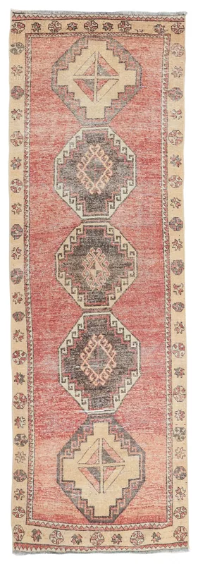 Full overhead view of a 3'2" x 10'1" rust and beige geometric Anatolian runner rug