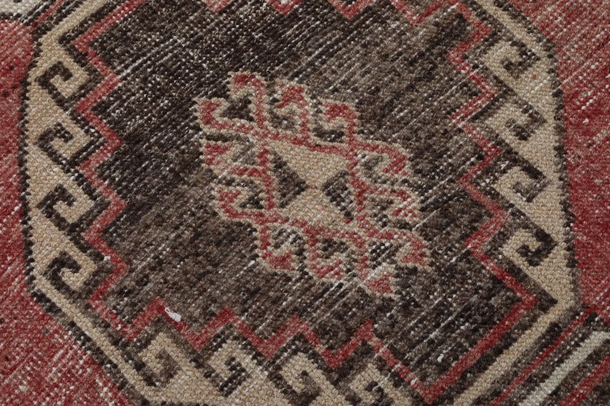 Intricate detail of a central tribal motif within the geometric design of the runner
