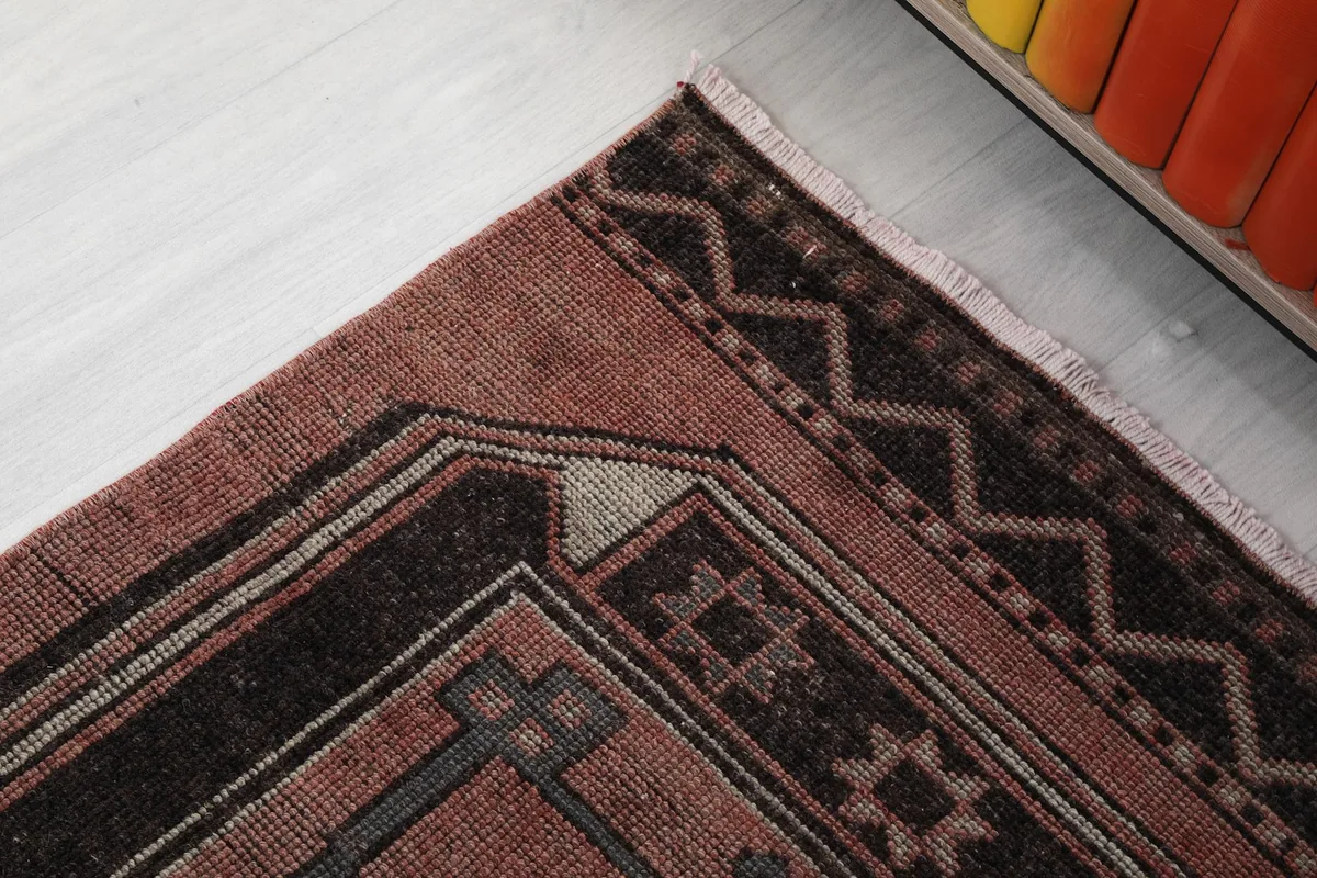 Detailed view of the rug's border and a portion of a medallion, showcasing the tribal patterns.