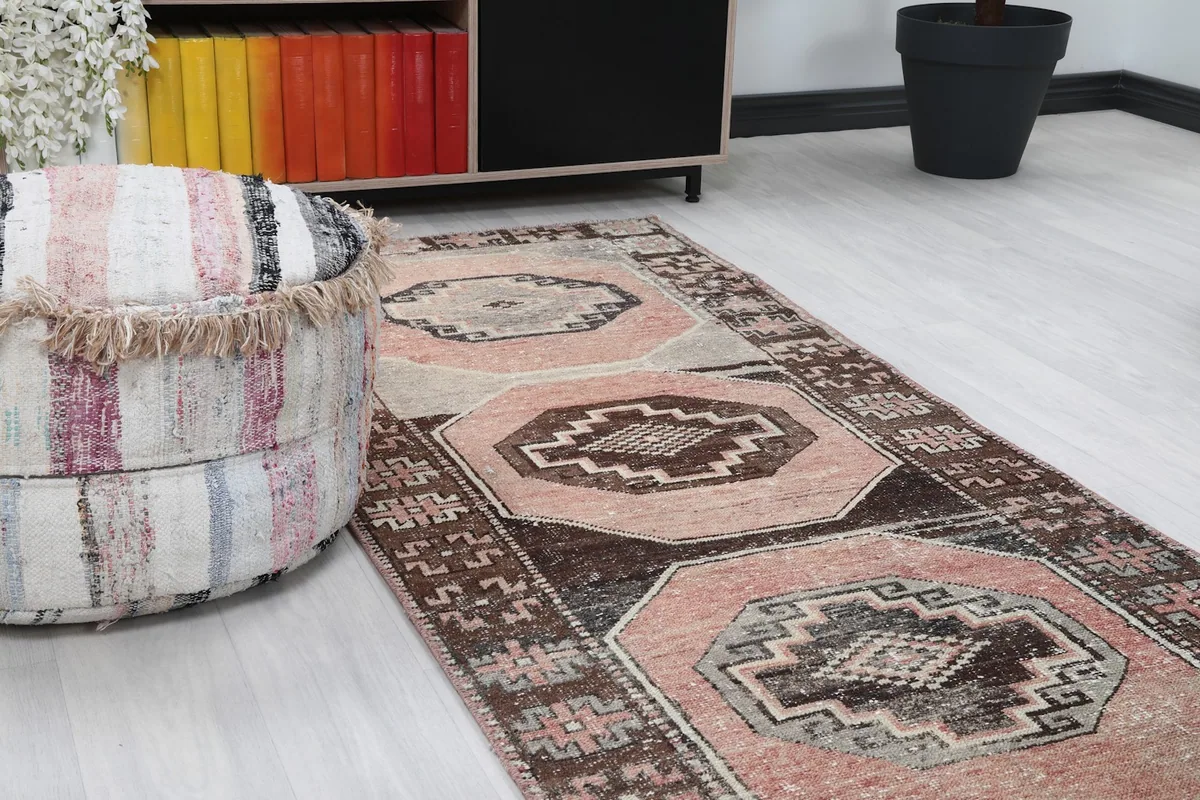 Close-up angle view of the runner rug's pattern and texture next to a pouf