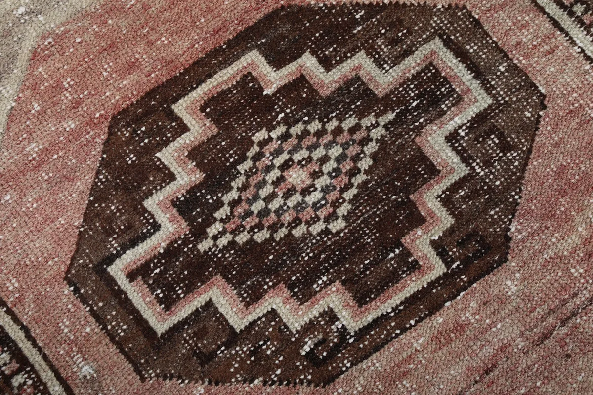 Close-up of the geometric design within a medallion, highlighting color variations