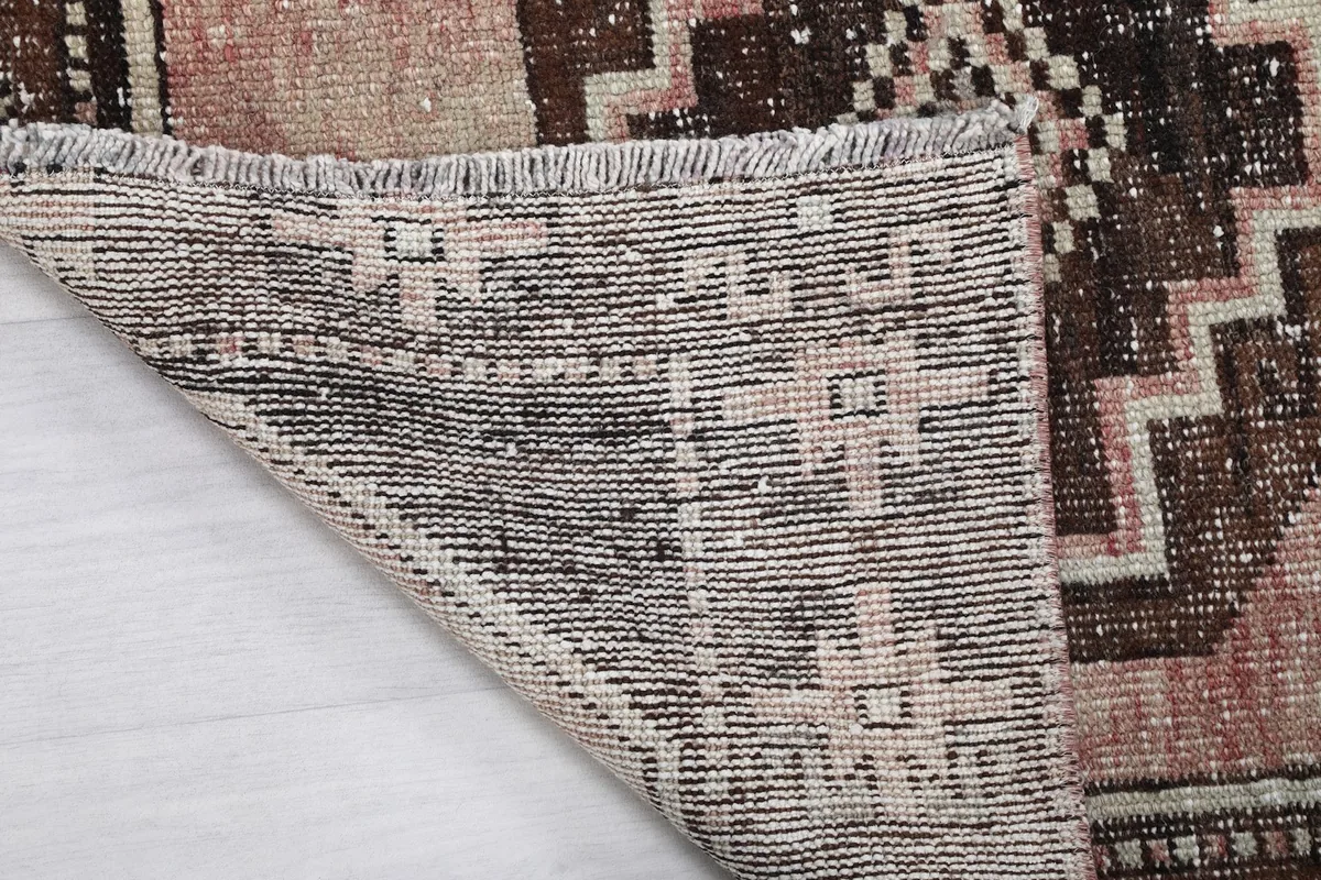 Close-up of the rug's fringe and the reverse side, showing construction