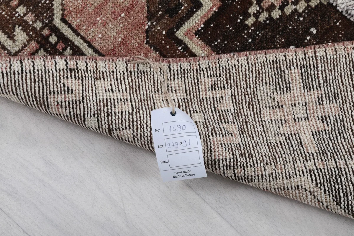 Back of the rug with a size tag, showing the hand-knotted texture