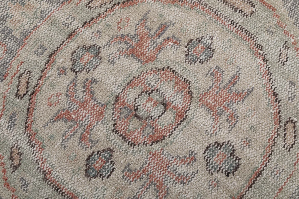 Very close detail of the medallion's faded wool pile and intricate knotting