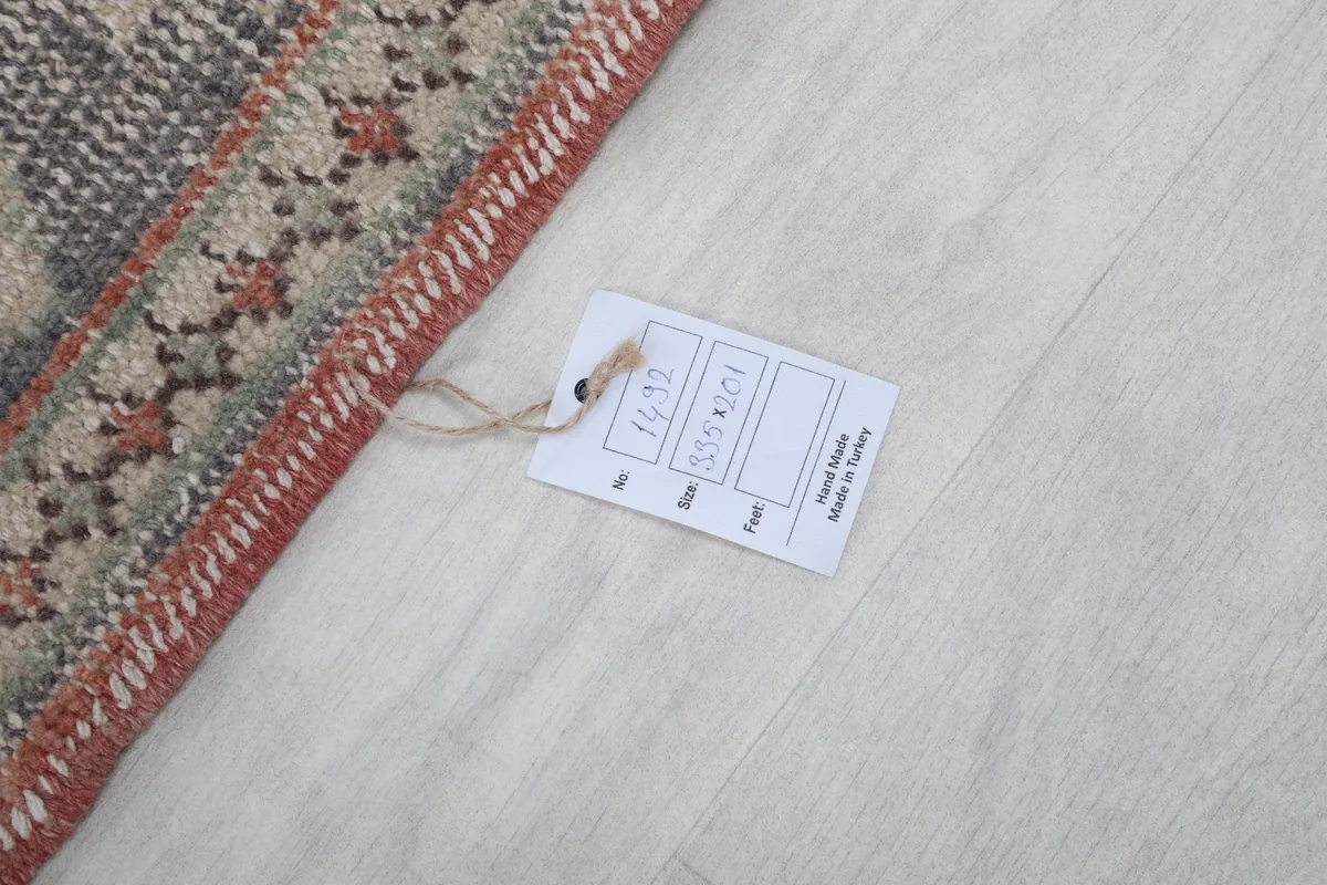 Product tag attached to the rug, displaying size and material information