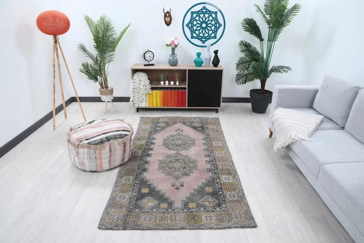 Vintage pink rug in a modern living room setting with a light gray sofa