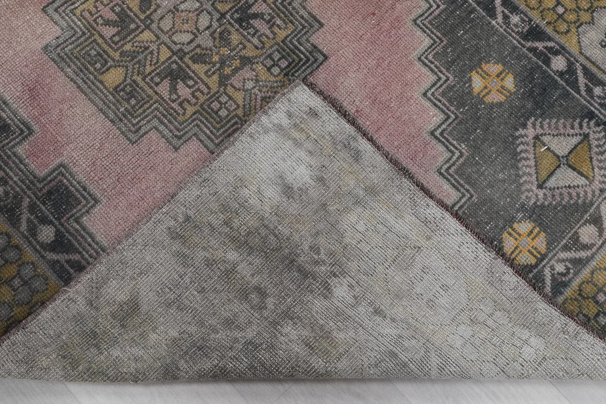 View of the back of the rug, showing the hand-knotted cotton foundation