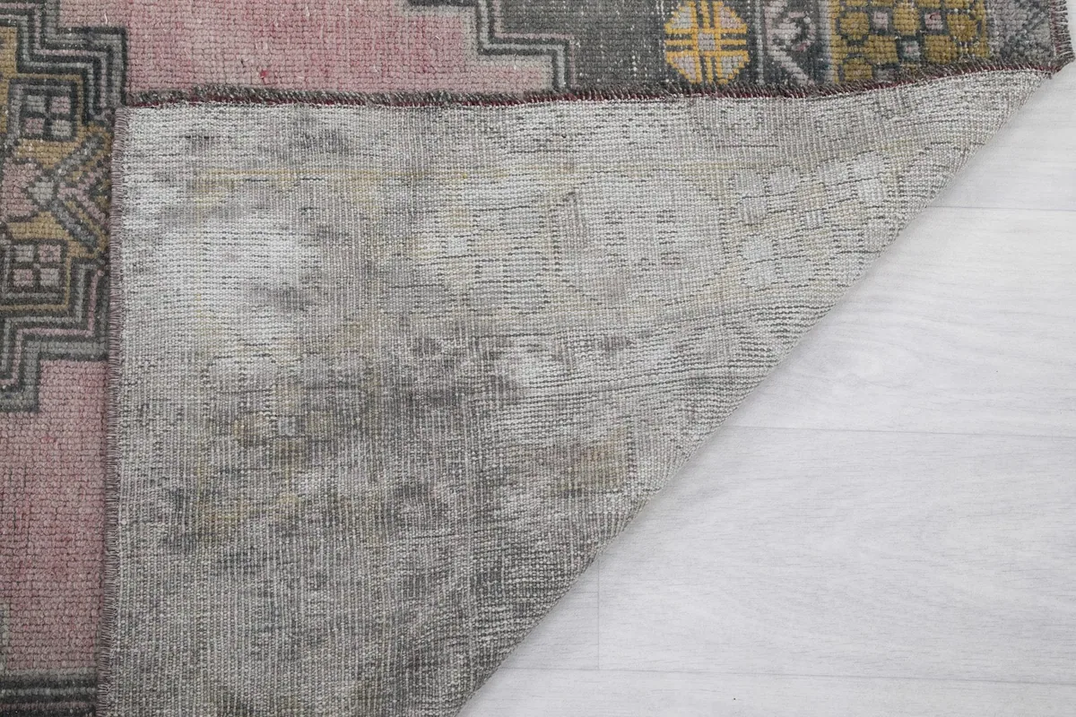 Close-up of the back of the rug, revealing the weave and vintage condition