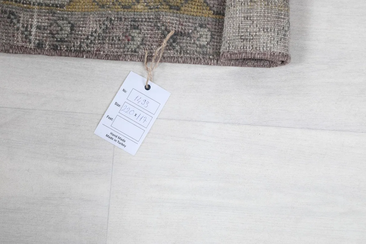 Rolled corner of the rug with the product tag showing origin and dimensions