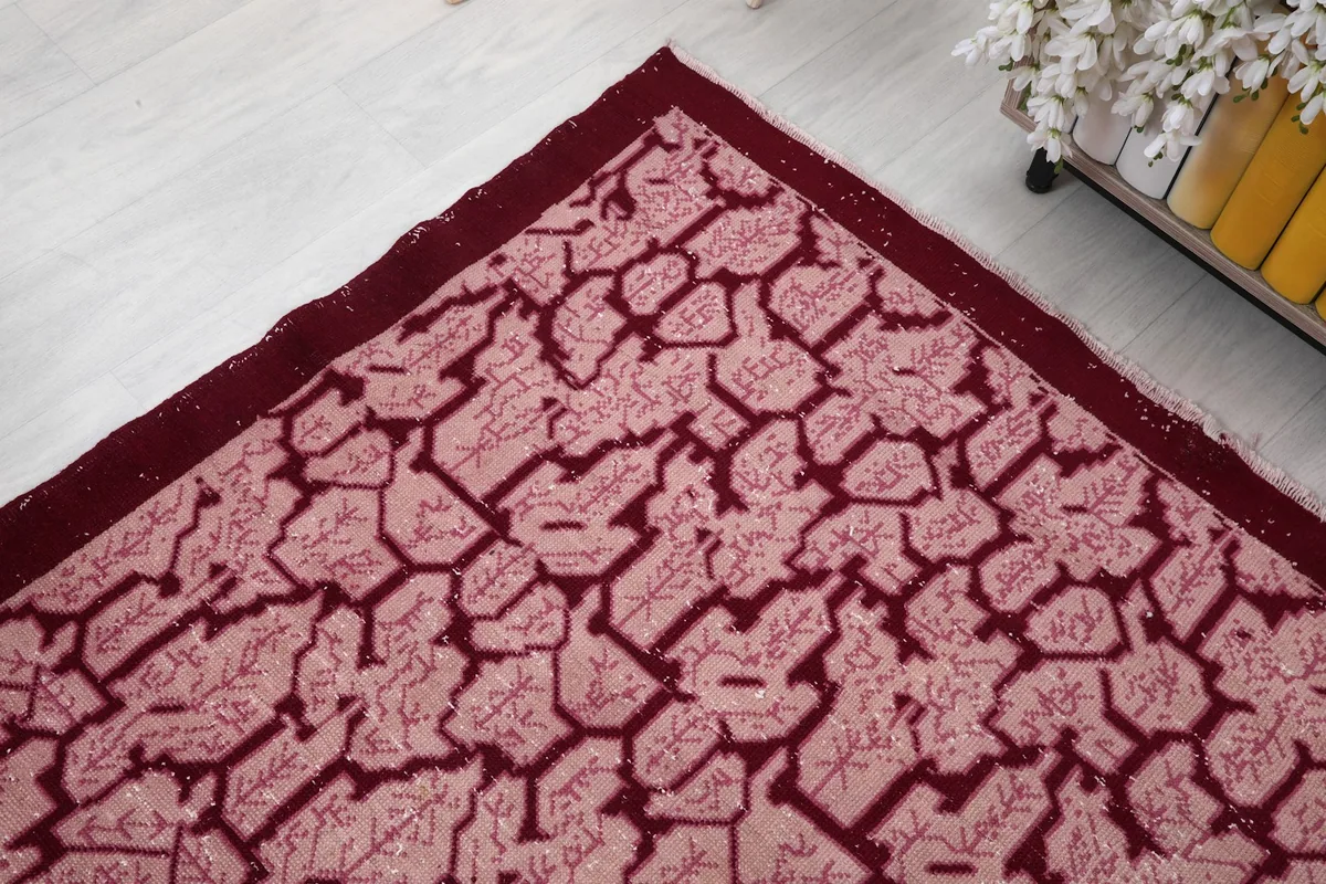 Corner detail of the vintage rug showing the geometric pattern and border