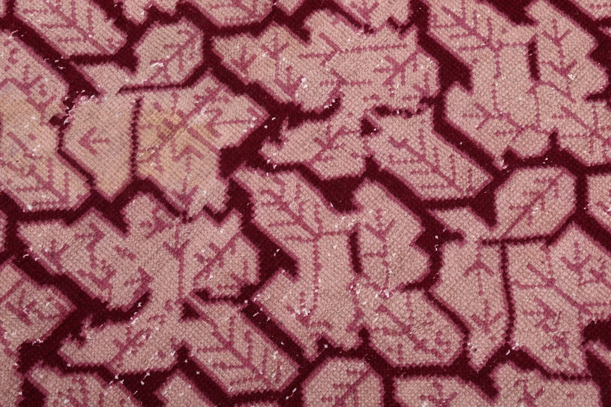 Detailed view of the low wool pile and hand-knotted texture of the rug