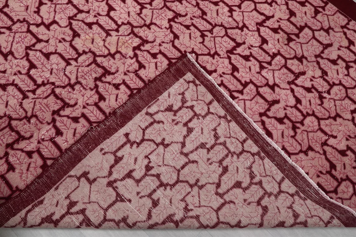 Folded corner revealing the cotton foundation and reverse side of the hand-knotted rug