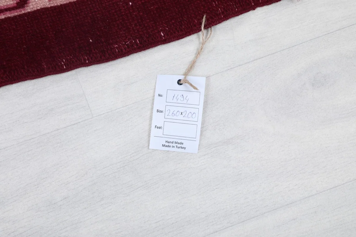 Product tag on the floor next to the vintage Anatolian rug