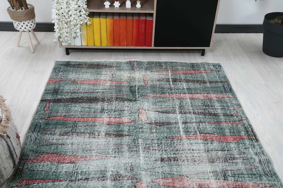 Overhead view of the green and rose rug in a room, showcasing its full pattern