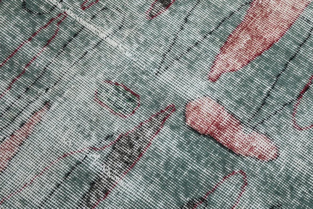 Close-up of the low wool pile and hand-knotted texture of the vintage rug