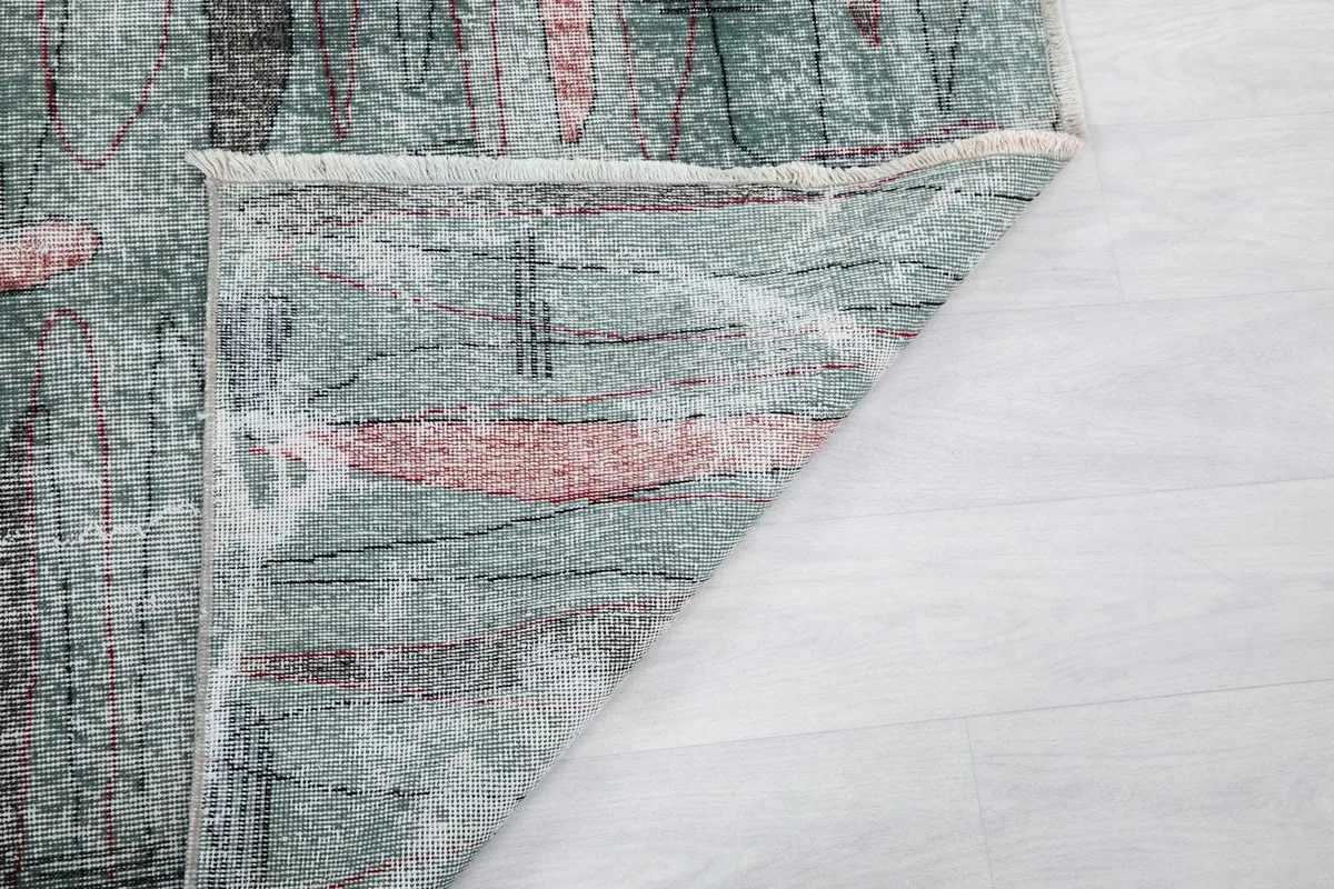 Underside view of the rug, revealing the tightly woven cotton foundation