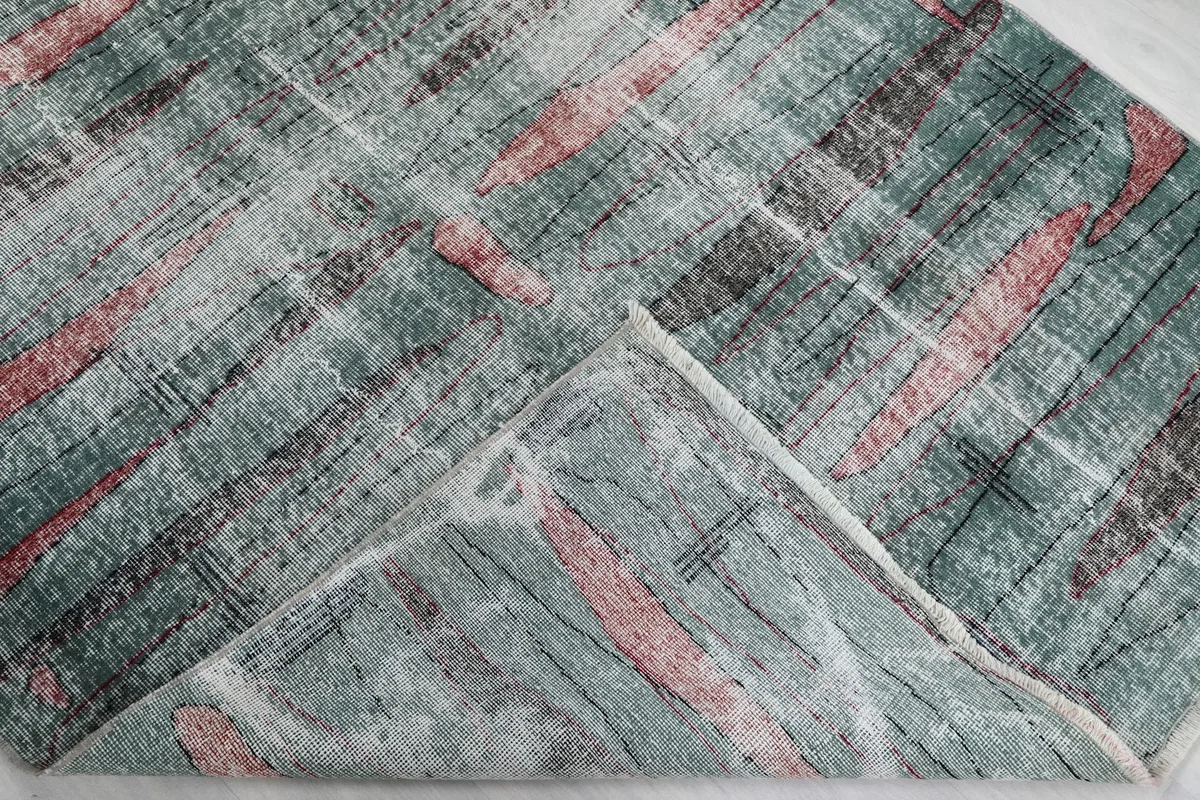 Folded corner of the rug, showing the wool pile on cotton foundation
