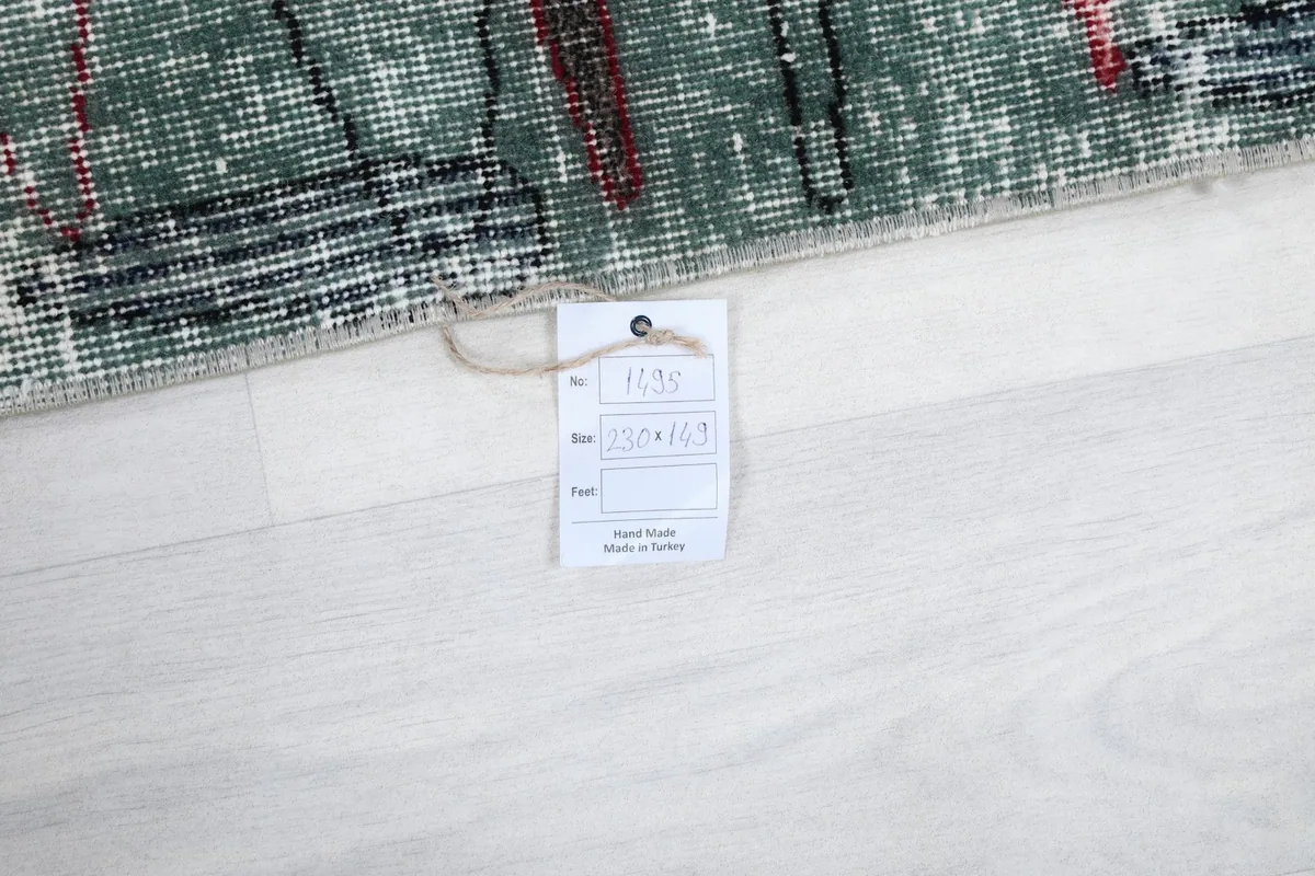 Product tag on the rug, indicating hand-knotted origin from Turkey and size