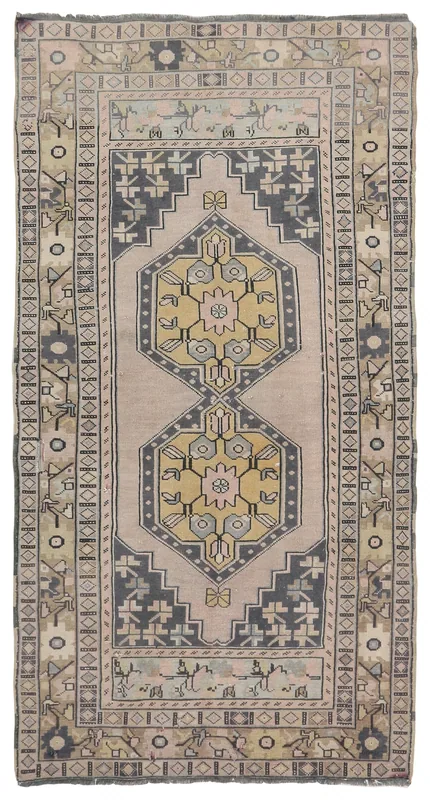 Full top view of the beige and charcoal geometric medallion vintage Anatolian rug