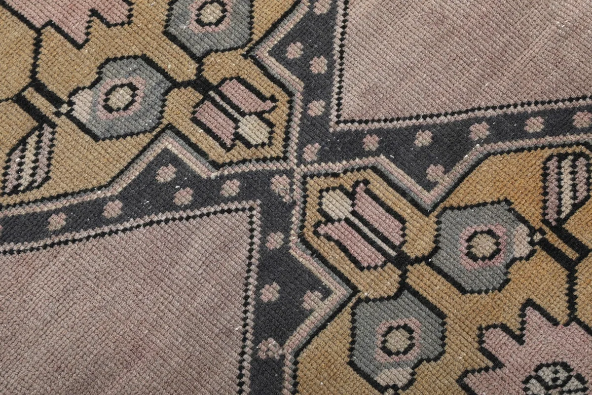 Macro view of the hand-knotted wool pile, highlighting color variations and weave